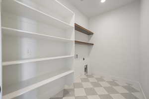 Laundry room with light flooring, recessed lighting, and electric dryer hookup