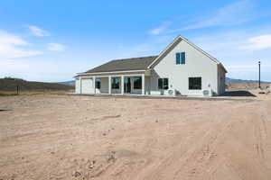 Rear view of house with a patio area and stucco siding