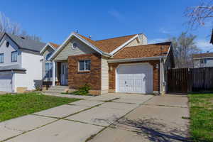 View of front of house featuring driveway, an attached garage, brick siding, and roof with shingles