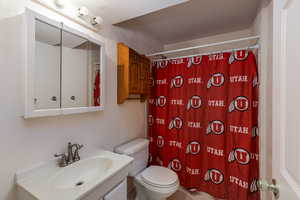 Bathroom with a textured wall and vanity