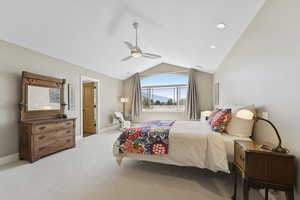 Carpeted bedroom featuring vaulted ceiling, a ceiling fan, and recessed lighting