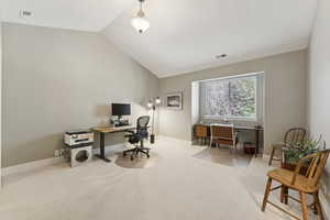 Home office featuring light carpet and lofted ceiling
