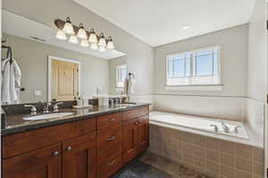 Bathroom with double vanity and a garden tub