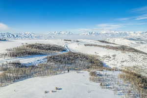 Snowy aerial view featuring a mountain view