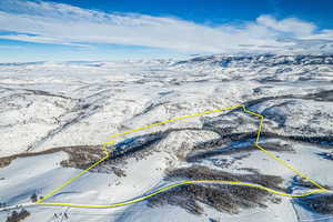 Snowy aerial view featuring property boundaries highlighted