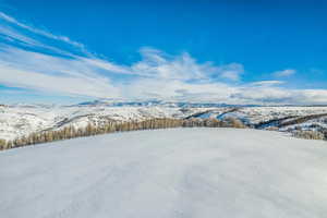 Snowy aerial view with a mountain view