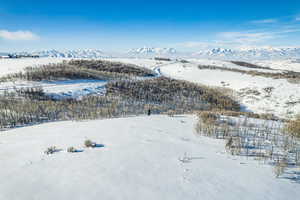 Snowy aerial view featuring a mountain view