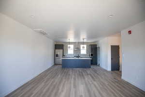 Unfurnished living room with dark wood finished floors and baseboards