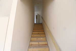 Staircase featuring baseboards