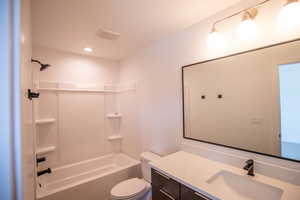 Full bath featuring vanity, shower / bathtub combination, and recessed lighting