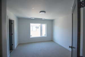 Unfurnished bedroom with carpet floors and baseboards