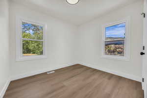 Spare room with wood finished floors and baseboards