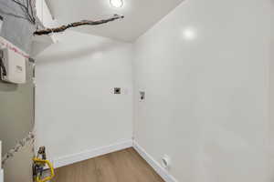 Washroom featuring light wood-style flooring, electric dryer hookup, and washer hookup