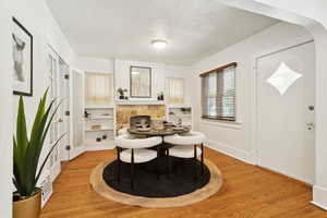 Dining area featuring light wood finished floors and baseboards