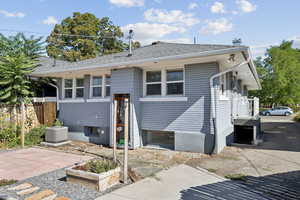 Back of property with roof with shingles