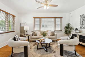 Living area featuring wood finished floors and a ceiling fan