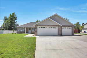 Ranch-style house featuring brick, a 3 car garage, and driveway