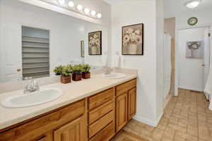 Bathroom featuring double vanity and a shower with curtain