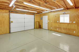 Detached garage/shop with rolling garage door and plenty of outlets.