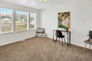Home office featuring carpet and baseboards