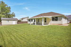 Rear view of property with a covered patio.