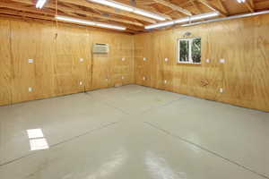 Detached garage/shop with epoxied floor and climate control unit.