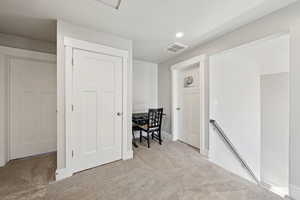 Upstairs hallway with desk, light colored carpet, and recessed lighting. 2nd washer/dryer hookups in the closet