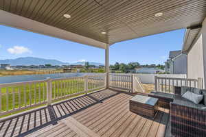 Deck featuring a fenced backyard, a residential view, and unobstructed mountain views