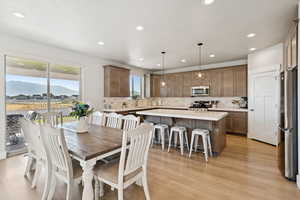 Dining room with recessed lighting, light LVP flooring, and a mountain view