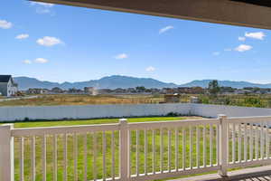 Fenced backyard featuring a mountain view and a residential view.  Horse property (1 acre) is past the white vinyl fence
