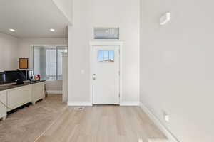 Foyer featuring light LVP flooring and recessed lighting