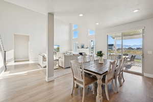 Dining room featuring LVP finished floors, recessed lighting, and a high ceiling