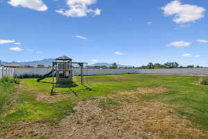 View of yard with a mountain view and a playground