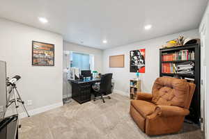 Bedroom/office area featuring carpet floors and recessed lighting