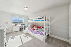 Bedroom with light carpet and a desk