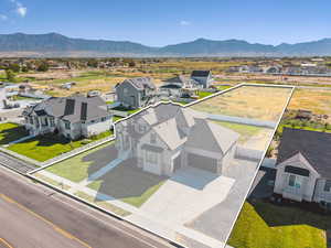 Aerial perspective of suburban area featuring property parcel outlined and mountains. 1.28 acres fenced