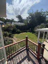 Deck featuring a lawn