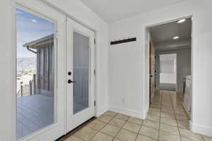 Mud room area, doorway to outside featuring tile patterned flooring and french doors