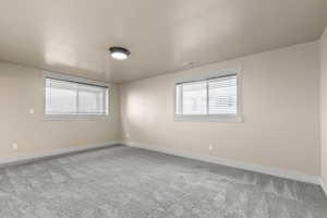 Empty room featuring light carpet