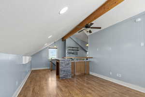ADU above the garage - living space with wood-type flooring and a textured ceiling