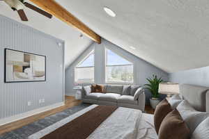 ADU above the garage - living area with wood finished floors and ceiling fan