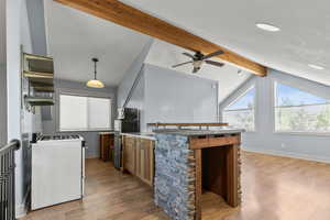 ADU above the garage - kitchen with light wood-style flooring, gas range gas stove, a ceiling fan, and stainless steel microwave