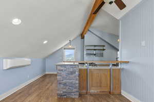 ADU above the garage - with wood-type flooring, light countertops, and decorative light fixtures