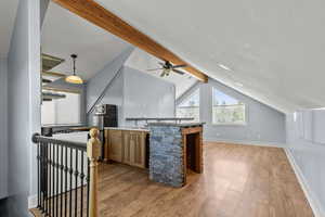 ADU above the garage with additional living space featuring light wood-style flooring and baseboards