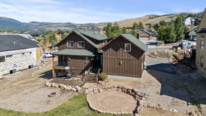 View of back of home with a mountain view and a residential view