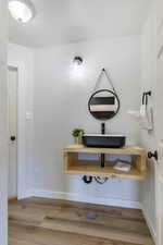 Bathroom with a sink and wood finished floors