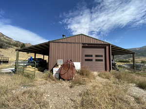 View of pole building featuring a mountain view and driveway