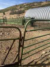 Gate featuring an outbuilding, an exterior structure, and a rural view