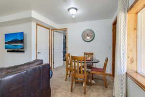 Dining space with light colored carpet and baseboards