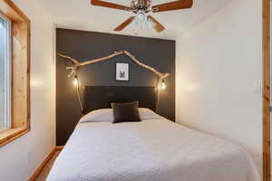 Bedroom with ceiling fan and baseboards